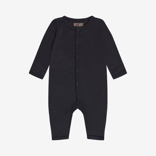 Romper Dark Navy – TENCEL™ & merino wool – Huttelihut: front view of the dark blue romper with button closure.