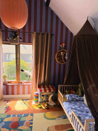 Brede Strepen Bordeaux Blauw – Atelier Chien: wallpaper in a kids' room with a bed and paper lantern.