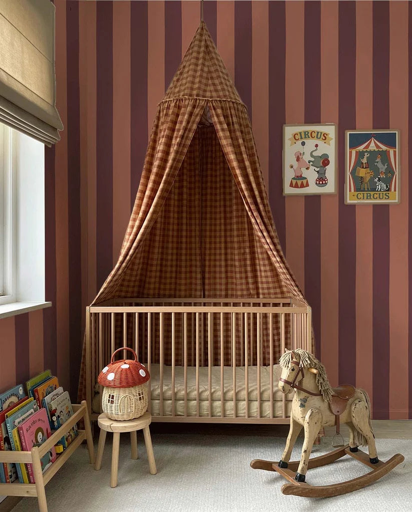 Brede Strepen Bordeaux Zalm – Atelier Chien: wallpaper in a nursery with a bassinet and canopy.