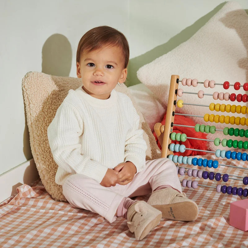 Mouse Wool Slippers – Wool kids slippers with suede sole – MELTON: baby sitting among toys wearing the slippers.